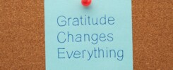 Sticky note on corkboard reading “Gratitude Changes Everything,” representing intentional leadership, reflection, and thoughtful brand building.